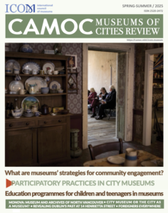 Cover of CAMOC Review magazine showing room with cabinet with plates and an open door onto a group of women sitting on a bench